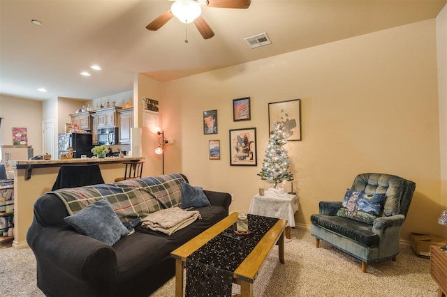 living room featuring light colored carpet and ceiling fan