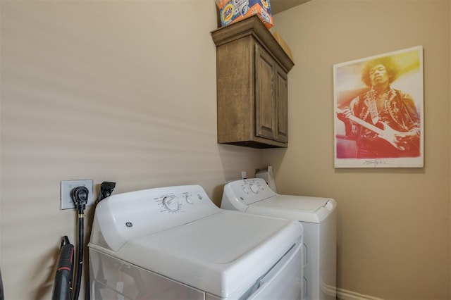 laundry area featuring washer and dryer and cabinets