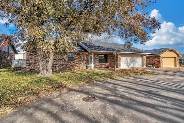 view of front of property with a garage and a front lawn