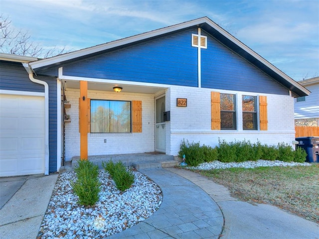 view of front of house with a porch and a garage