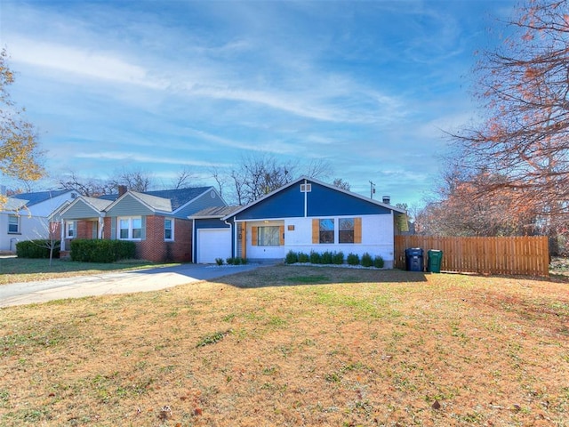 ranch-style home with a garage and a front lawn