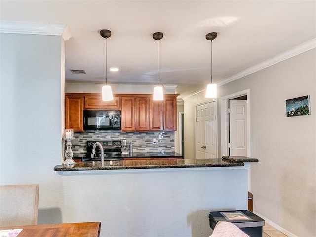 kitchen with kitchen peninsula, pendant lighting, and dark stone countertops