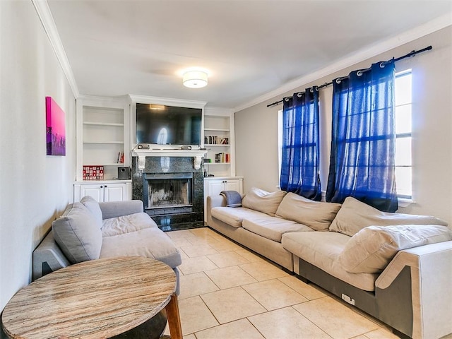 living room featuring light tile patterned flooring, built in shelves, crown molding, and a premium fireplace