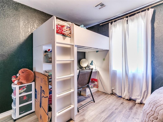 bedroom with wood-type flooring