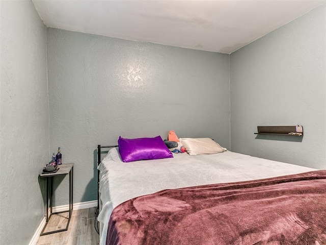 bedroom with wood-type flooring