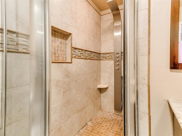 bathroom with tiled shower