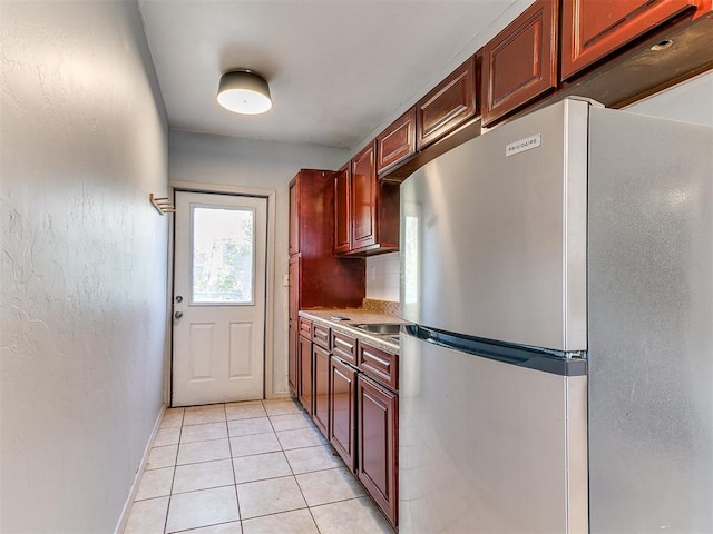 kitchen with stainless steel refrigerator and light tile patterned flooring