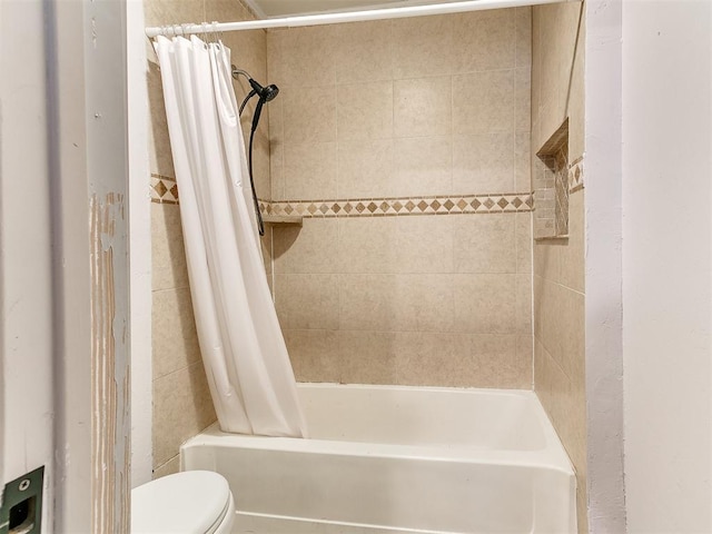 bathroom with shower / bath combo and toilet