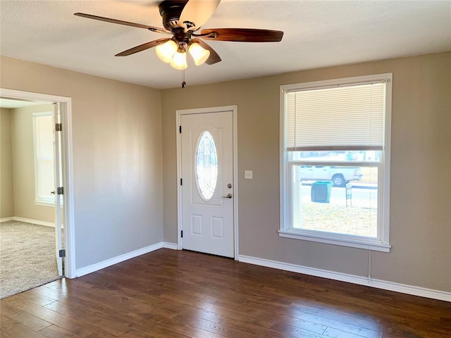 foyer entrance with dark wood-type flooring and ceiling fan