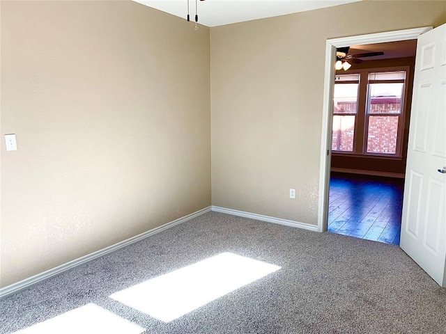 empty room with ceiling fan and carpet