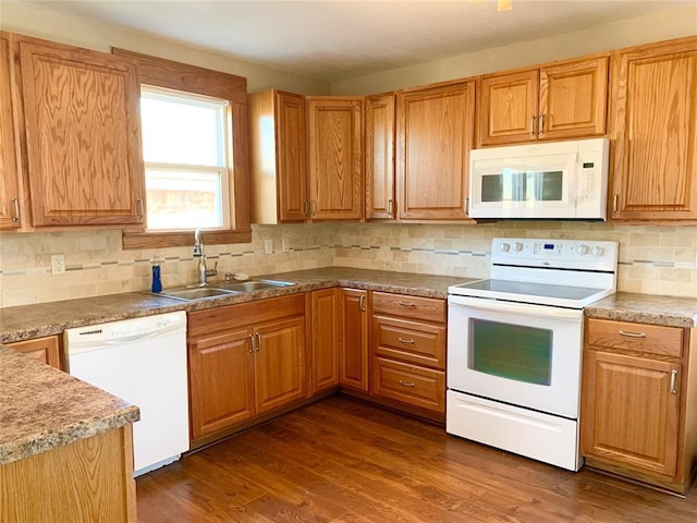 kitchen with decorative backsplash, dark hardwood / wood-style floors, sink, and white appliances