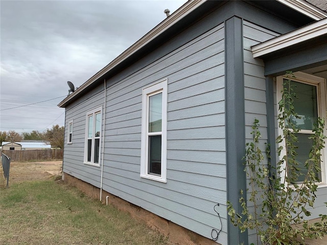 view of side of property with a yard