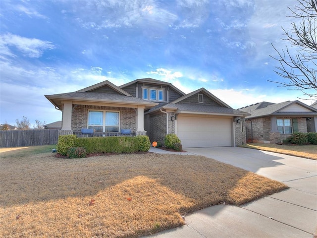 view of front facade with a porch, a garage, and a front yard