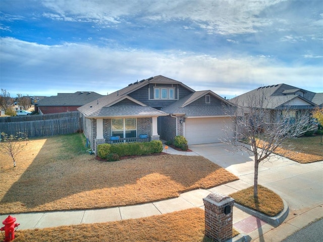 craftsman-style home featuring a front yard, a porch, and a garage