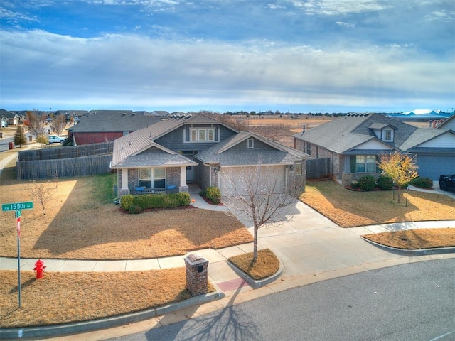 view of front of home with a porch, a garage, and a front lawn