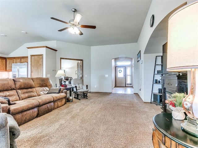 carpeted living room featuring ceiling fan and vaulted ceiling