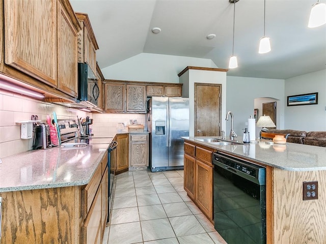 kitchen featuring black appliances, decorative light fixtures, a center island with sink, and sink