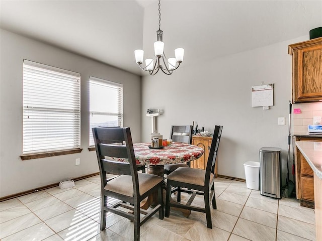 dining room featuring light tile patterned flooring and an inviting chandelier