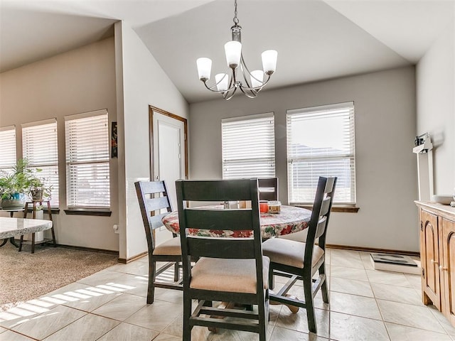 dining room with an inviting chandelier, light tile patterned floors, a wealth of natural light, and vaulted ceiling