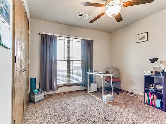 carpeted home office with ceiling fan