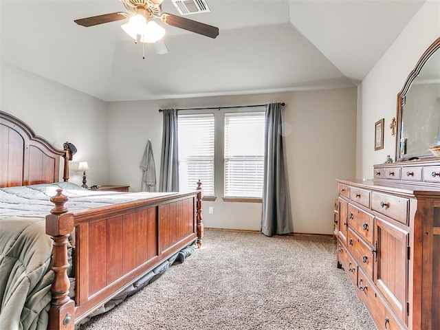 carpeted bedroom with ceiling fan and vaulted ceiling