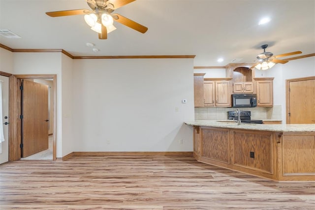 kitchen with black appliances, crown molding, light hardwood / wood-style flooring, decorative backsplash, and light brown cabinetry