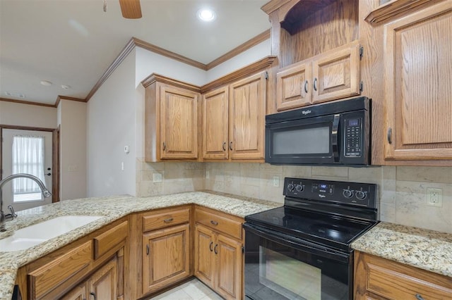 kitchen with black appliances, light stone counters, ornamental molding, and sink