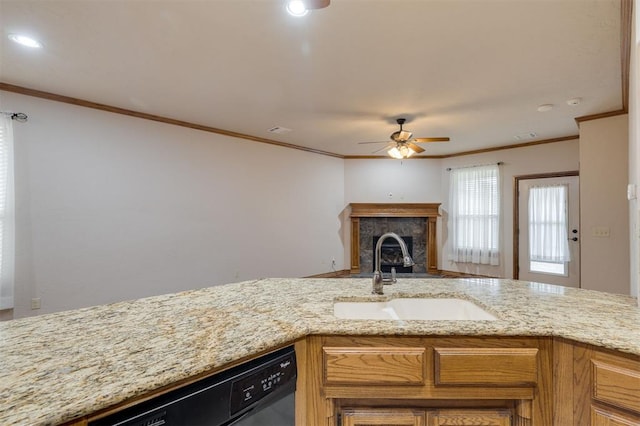 kitchen featuring light stone counters, ornamental molding, dishwashing machine, ceiling fan, and sink