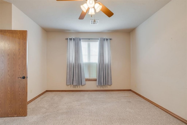 carpeted empty room featuring ceiling fan