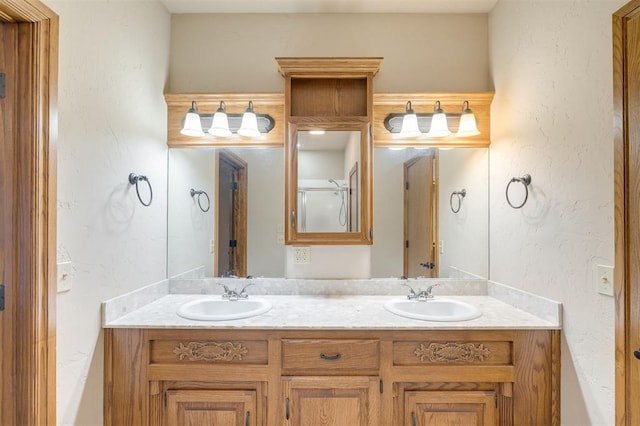 bathroom with vanity and a shower with door