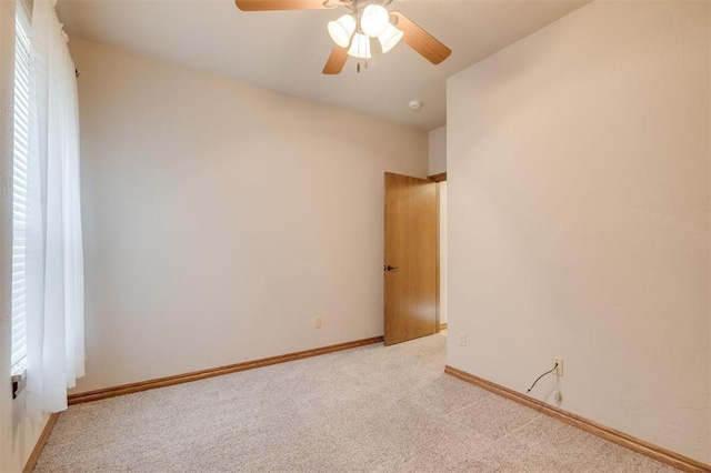 carpeted spare room featuring ceiling fan and a healthy amount of sunlight