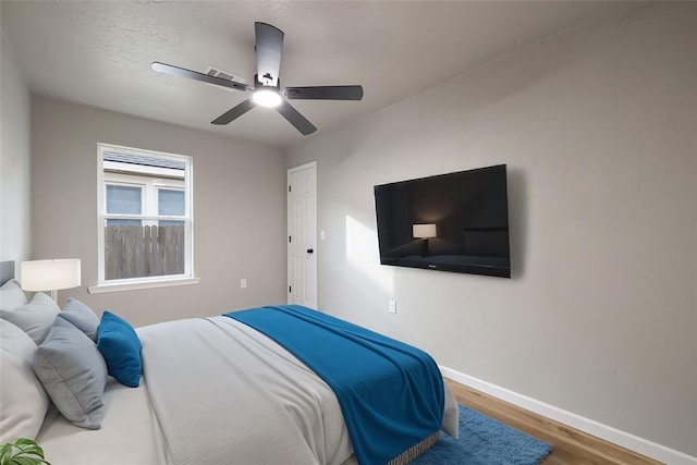 bedroom with ceiling fan and wood-type flooring