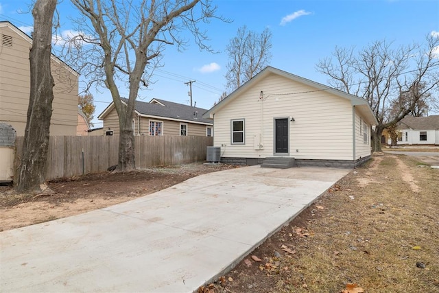 rear view of house with central AC