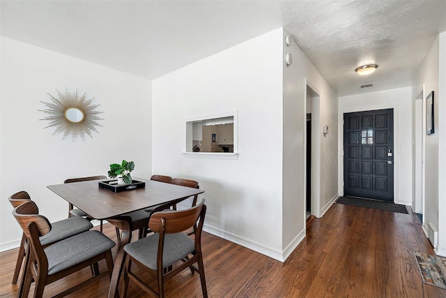 dining space featuring dark hardwood / wood-style floors