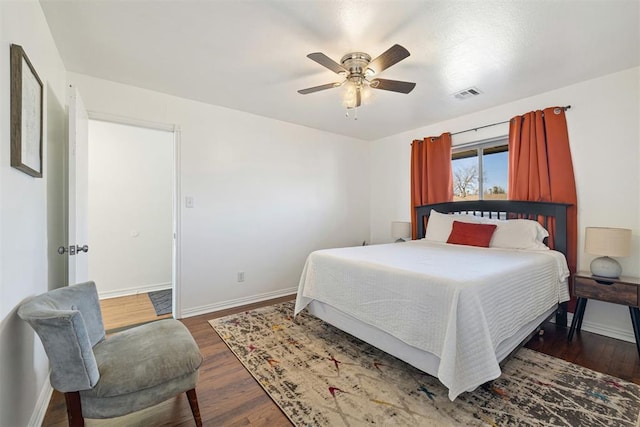 bedroom with ceiling fan and dark wood-type flooring