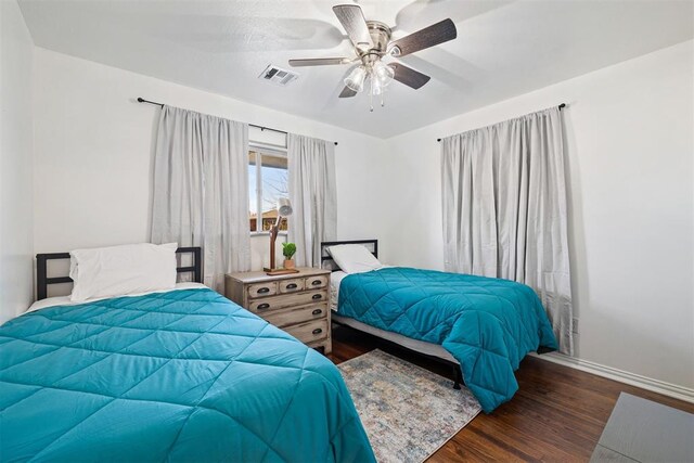 bedroom with ceiling fan and dark hardwood / wood-style flooring