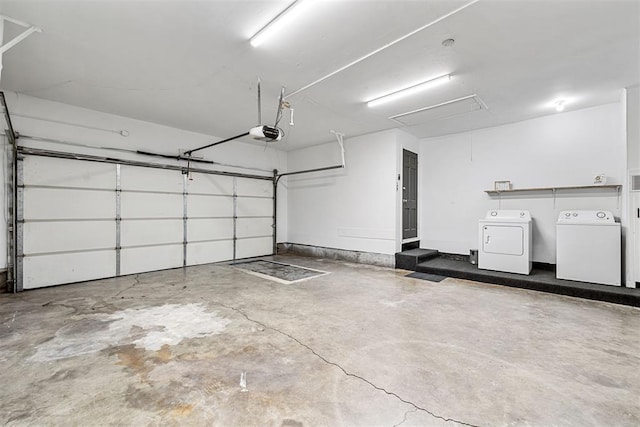 garage with independent washer and dryer and a garage door opener