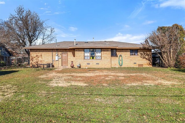 rear view of property with a lawn