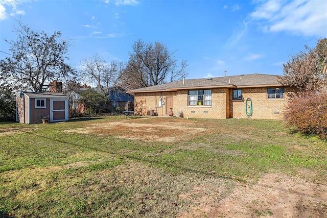 back of house featuring a storage shed and a lawn