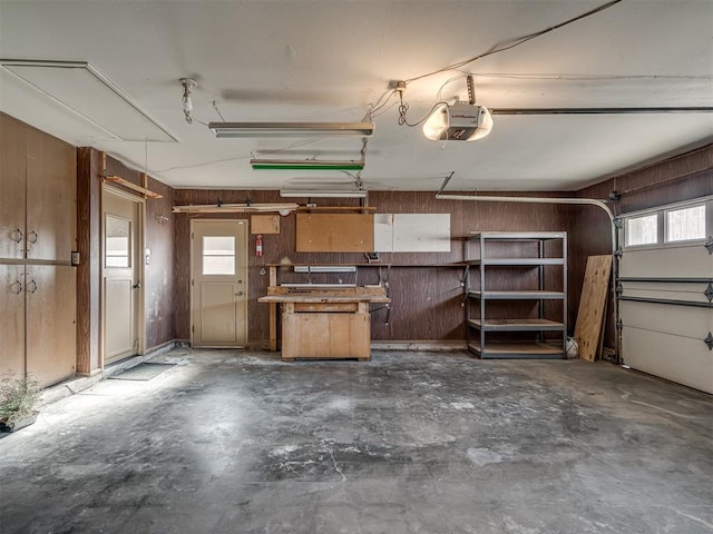 garage featuring wood walls and a garage door opener