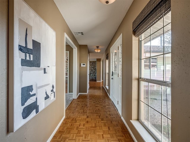 corridor with visible vents and baseboards