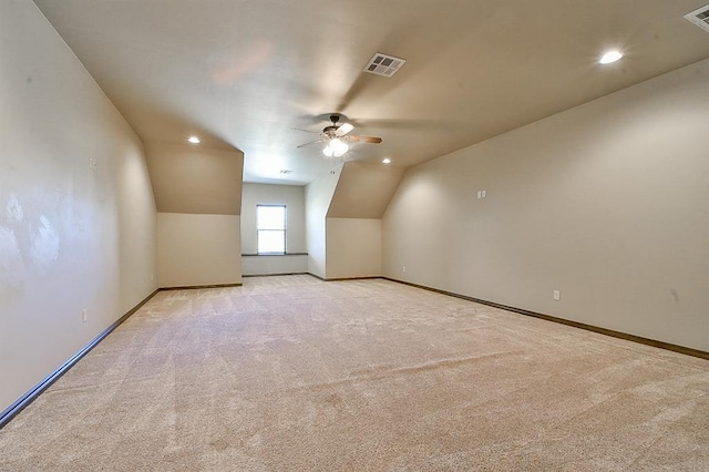 bonus room with light carpet, ceiling fan, visible vents, and baseboards