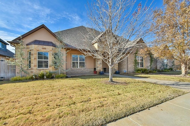 view of front of home with stone siding, a front lawn, and stucco siding