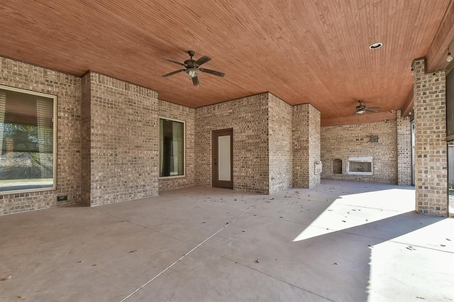 view of patio / terrace featuring ceiling fan and an outdoor brick fireplace