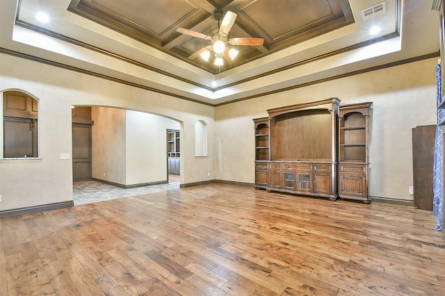 spare room featuring arched walkways, coffered ceiling, wood finished floors, visible vents, and ornamental molding