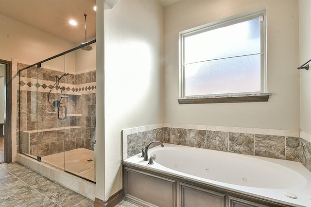 full bathroom featuring a jetted tub and a stall shower