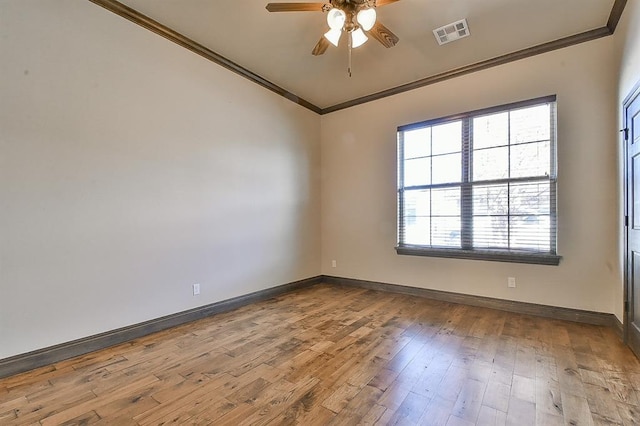 unfurnished room featuring crown molding, visible vents, light wood-style flooring, a ceiling fan, and baseboards