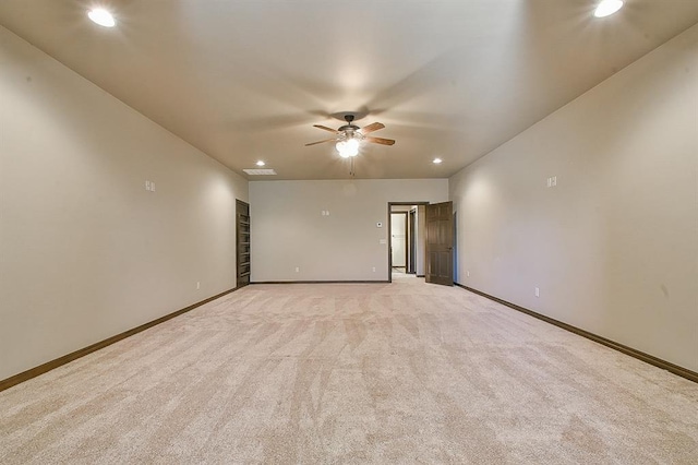 unfurnished room featuring light carpet, recessed lighting, a ceiling fan, and baseboards