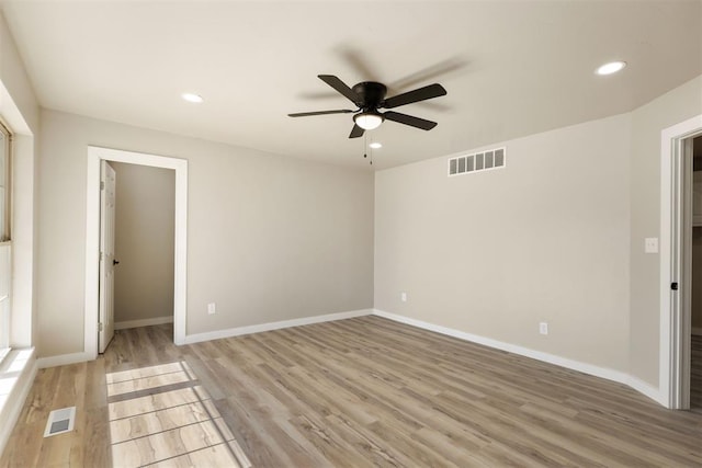 unfurnished bedroom with ceiling fan, light wood-type flooring, and a closet