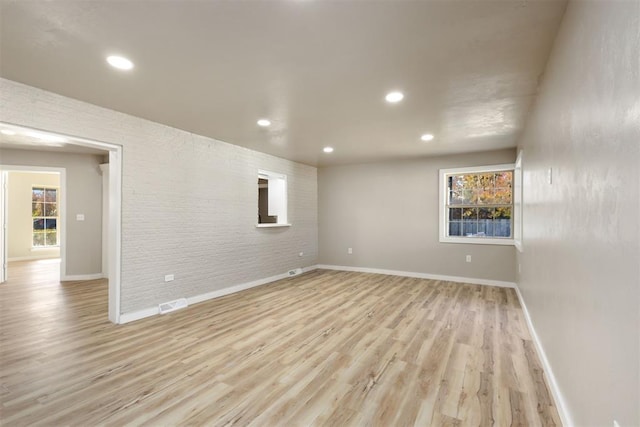 spare room with light hardwood / wood-style floors and a healthy amount of sunlight